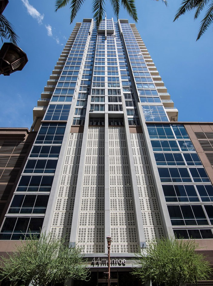 Upward view of 44 Monroe apartments with glass construction and large balconies.